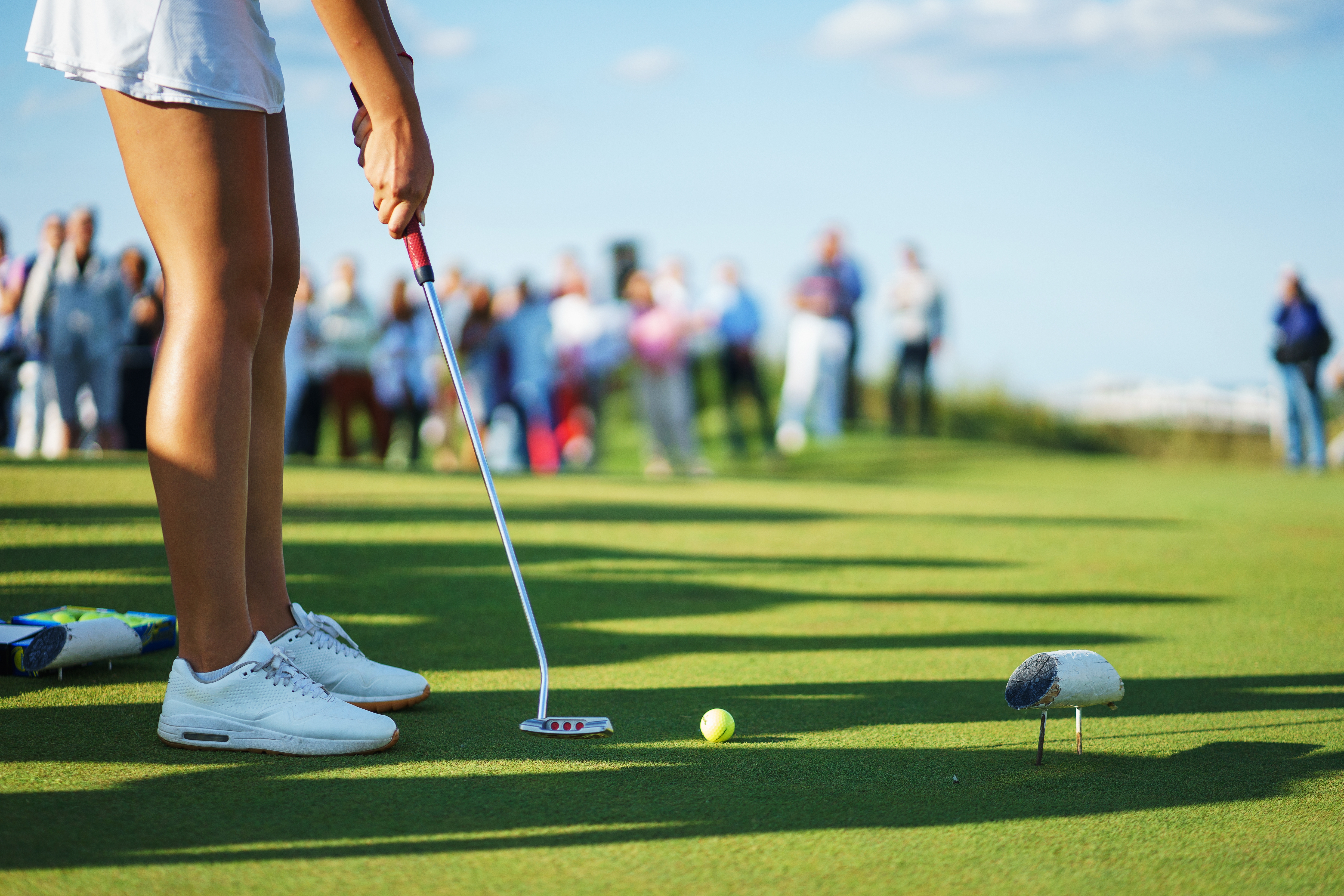 A player places a ball on the putting green